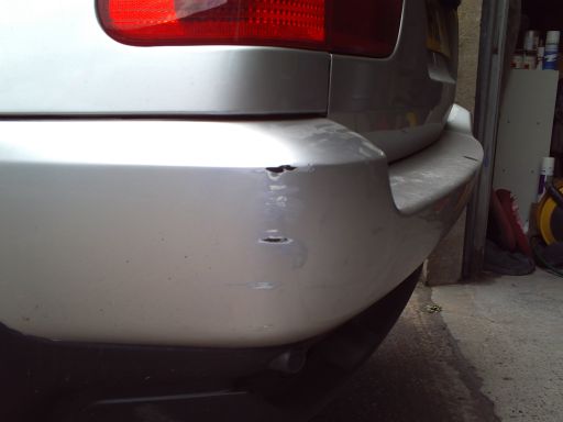 BMW X5 with damage to LH rear bumper corner