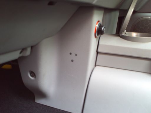 Centre console with damage caused by the fitment of a mobile phone holder and charger